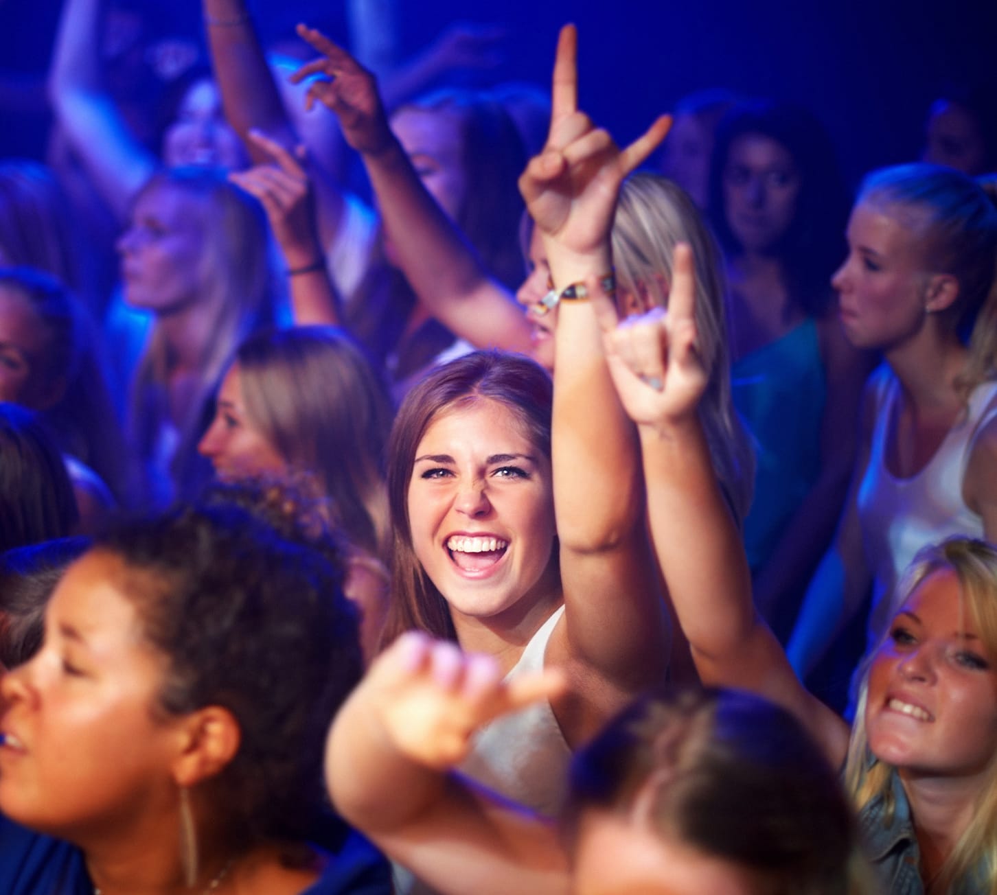 Woman in crowd enjoying music concert