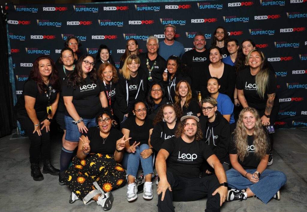 group of leap team members posing in front of convention photo op backdrop