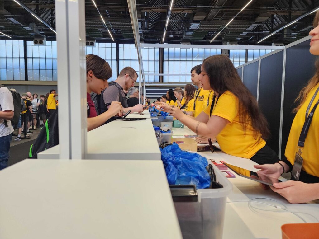team members in yellow shirts assisting at the event registration desk