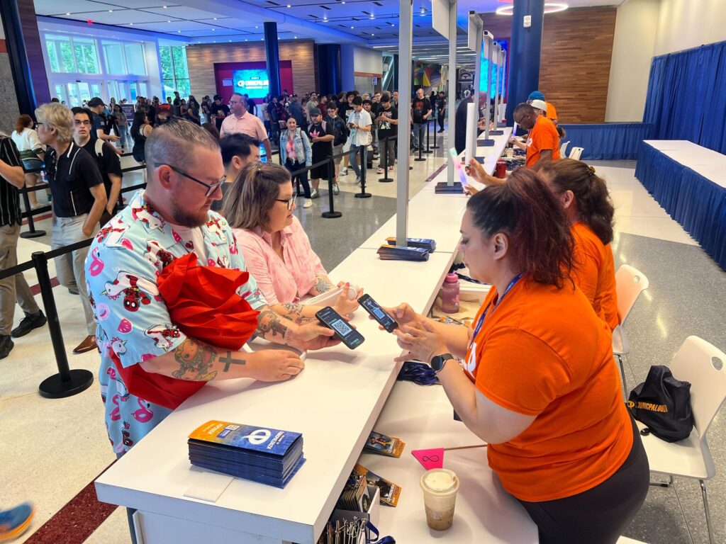 attendees getting their badges scanned in