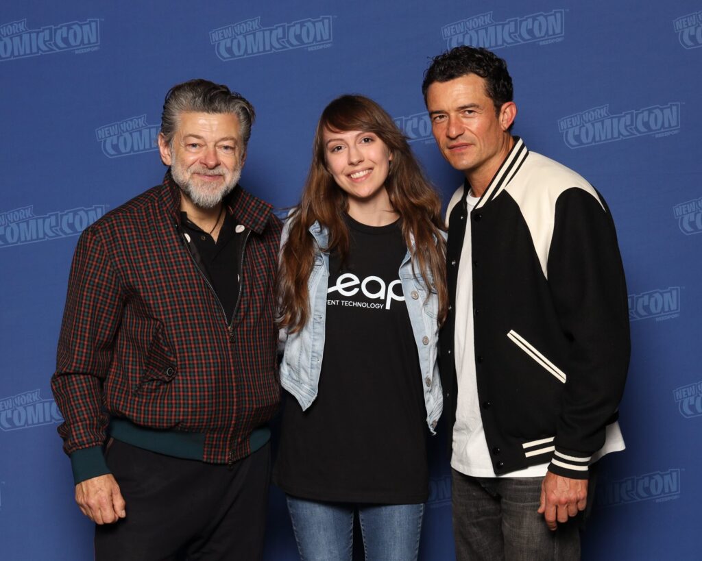 Leap Event Technology team member taking a photo with two celebrities at New York Comic Con