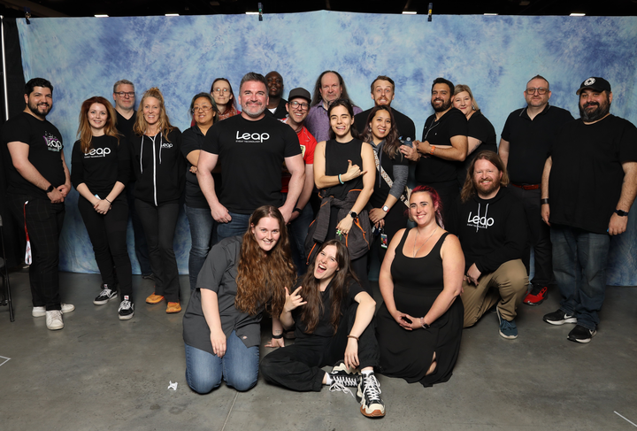 Leap Event Technology team members posing in front of a celebrity photo ops background