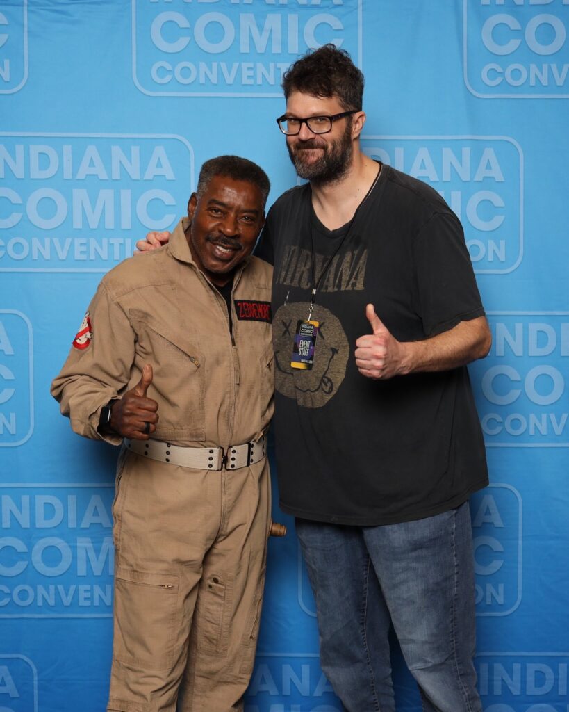 Andrew Thomas posing for a celebrity photo op with a Ghostbusters actor