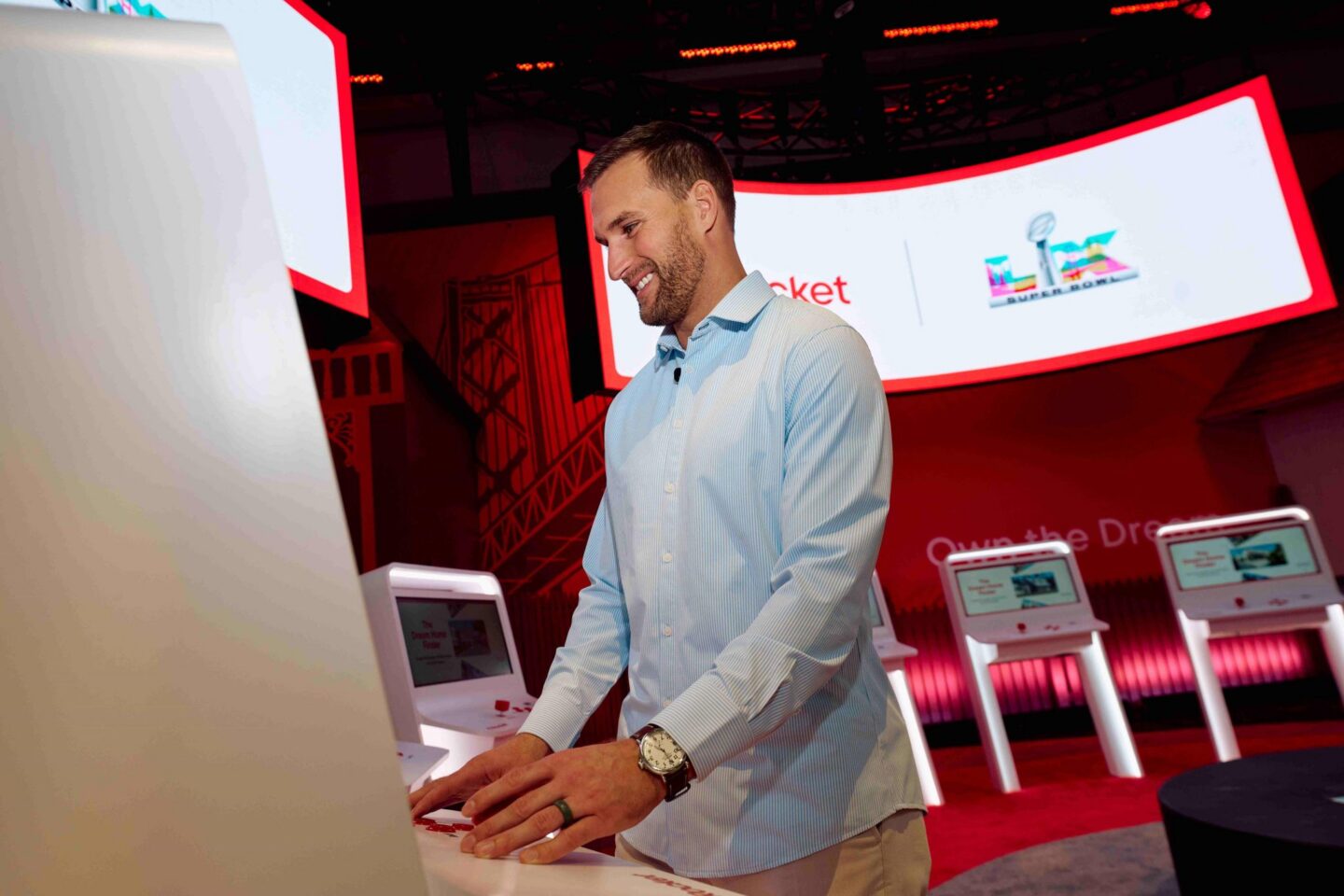 man in dress shirt interacting with Rocket Mortgage booth Dream Home Finder