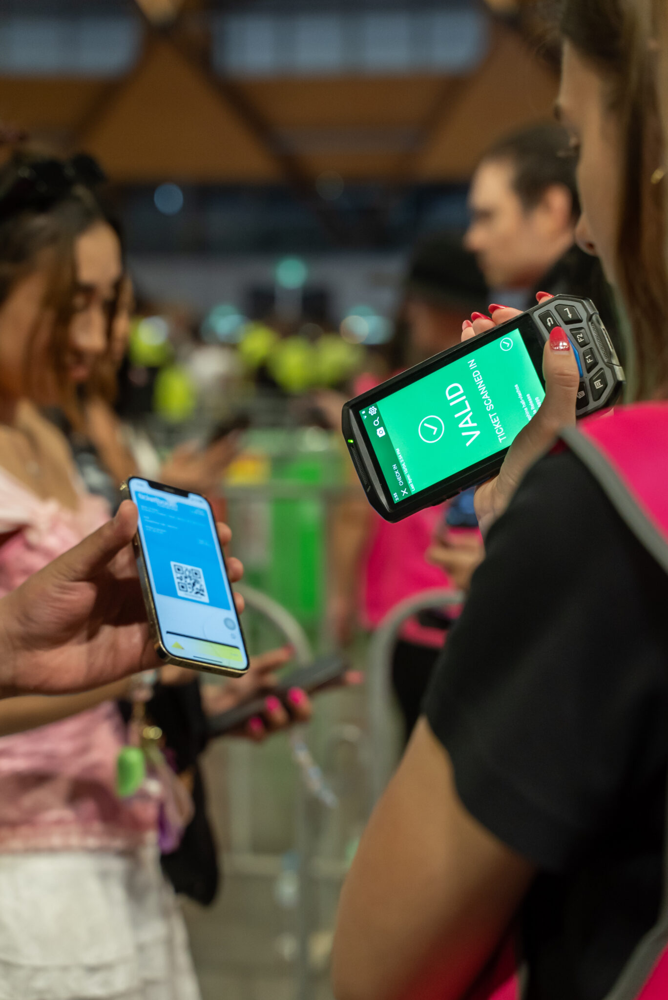An event-goer getting their ticket QR code scanned