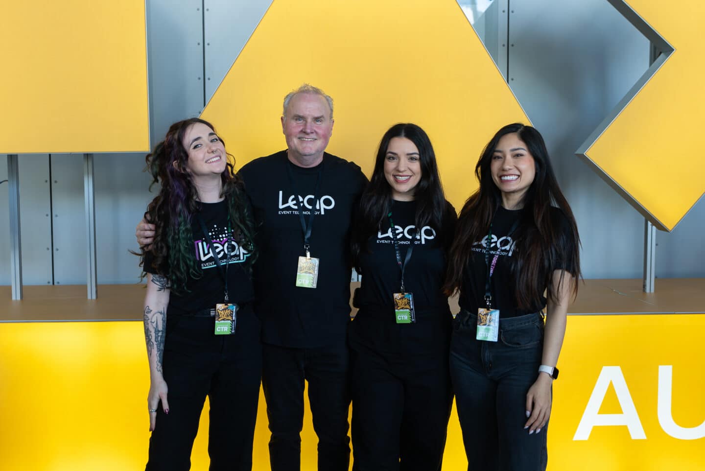 A team of 3 women and 1 man with Leap Event Technology shirts on at PAX AUS