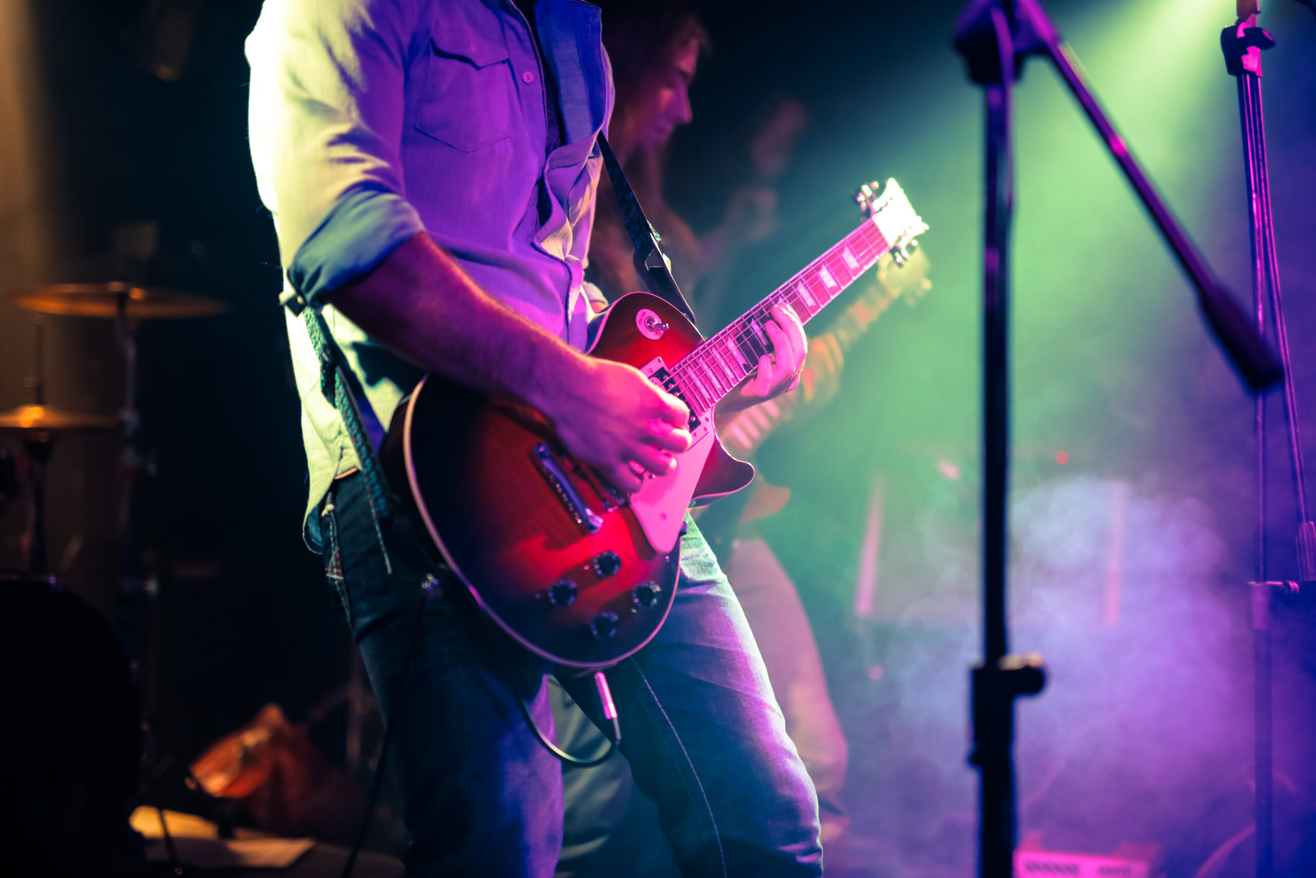 A guitarist playing an electric guitar at a rock concert