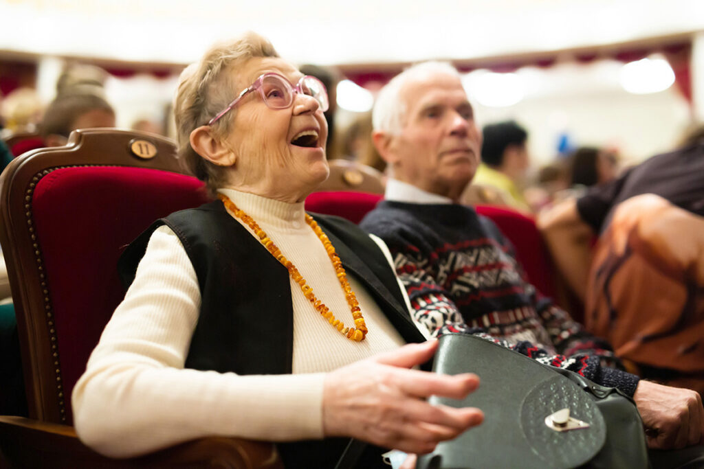 Elderly couple man and woman enjoying performance at opera and b older couple at a theater