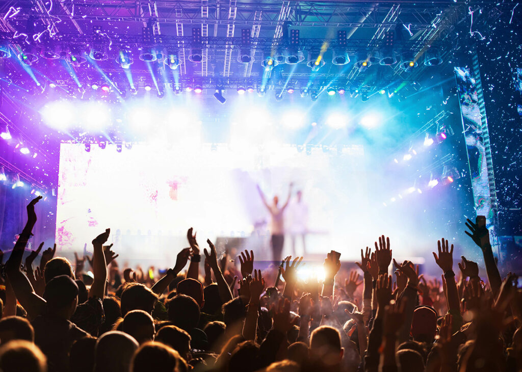 crowd partying stage lights live concert summer music festival music concert crowd looking at performer